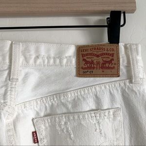 Mid rise white Levi jeans with rips